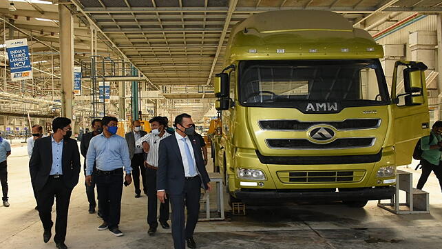 Himanshu Patel (wearing blue tie) at AMW Bhuj Facility with Triton EV Team 